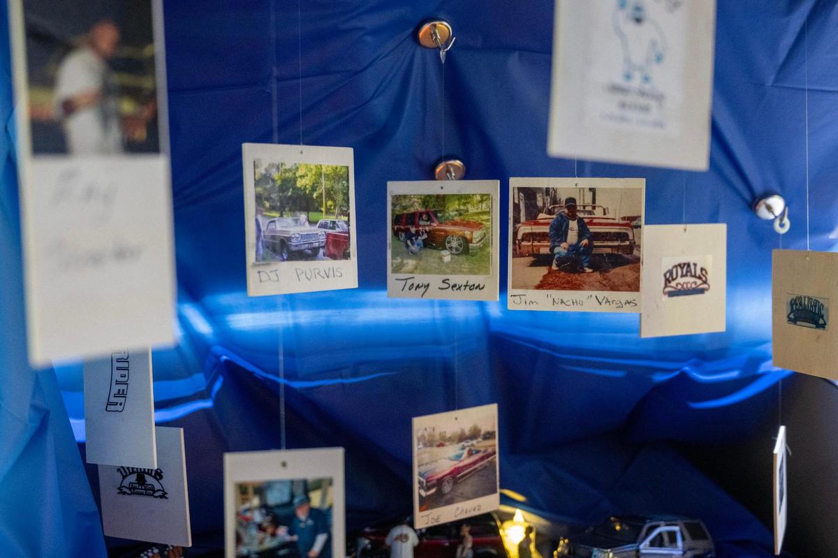 A variety of Polaroid photos are hung among the items in Pena’s trunk altar.