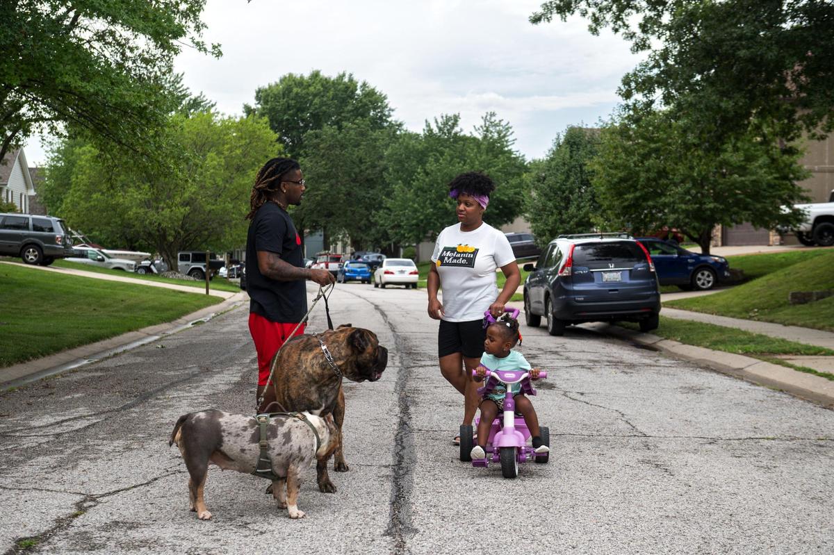 John Roddy, his wife Mika and their daughter Esrael take an evening walk with their dogs on a warm summer evening in Blue Springs.