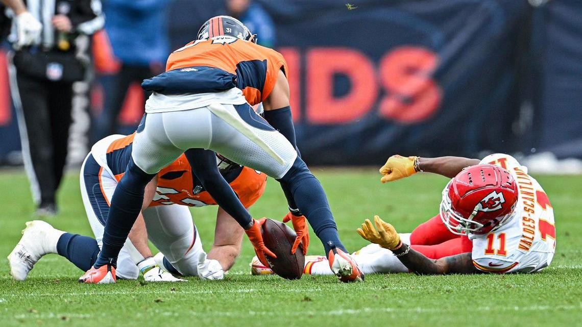 Denver Broncos safety Justin Simmons (31) scoops up the ball after Denver Broncos linebacker Josey Jewell (47) hit Kansas City Chiefs wide receiver Marquez Valdes-Scantling (11) to cause a fumble in the first half Sunday, October 29, 2023, at Mile High Stadium in Denver.
