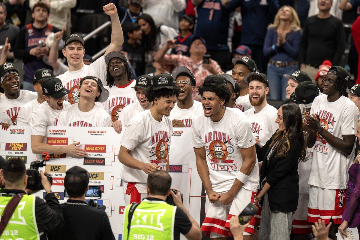 Arizona players celebrate after defeating the Houston 79-74 in the Big 12 Men's Basketball Tournament Championship game at T-Mobile Center on Saturday, March 14, 2026, in Kansas City.