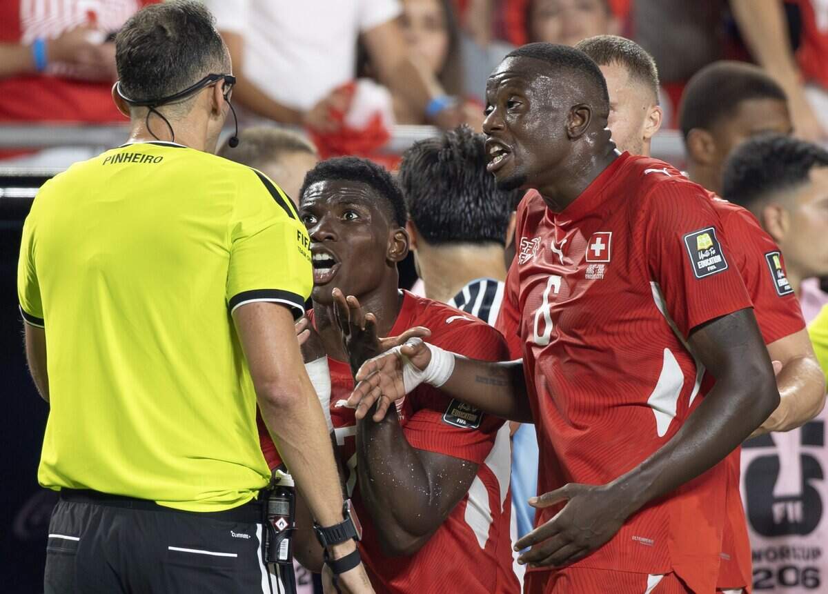 Switzerland forward Breel Embolo (7) pleads his case with the referee after picking up his second yellow card against Argentina during the FIFA World Cup quarterfinal match at Kansas City (Arrowhead) Stadium in Kansas City on Saturday, July 11, 2026.