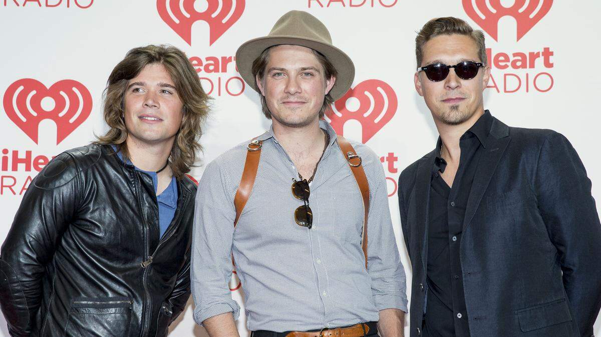 Zac, left, Taylor, and Isaac of Hanson, arrive at the iHeartRadio Music Festival in Las Vegas in 2013. The members of the 90s boy band now have 13 children and a new single.