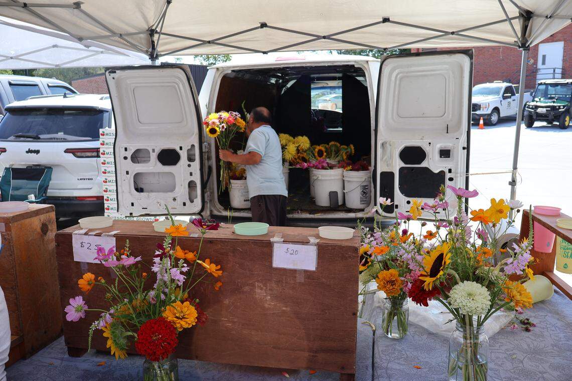 A vendor creates personalized flower arrangements.
