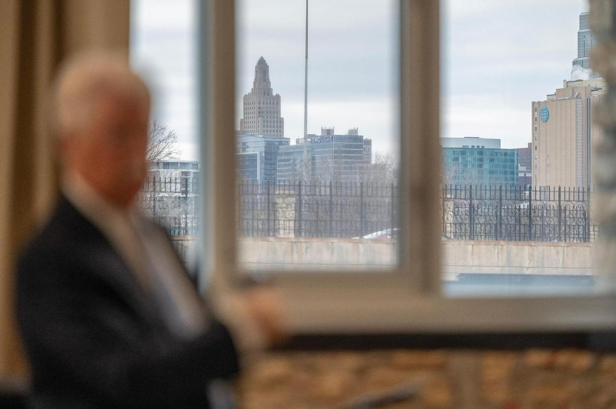 The Kansas City skyline is visible from a window at 2000 Vine St. on Tuesday, March 26, 2024, as John Sherman, owner of the Kansas City Royals, responds to questions during a community event addressing the sales tax for a new downtown ballpark for the Royals and renovations for Arrowhead Stadium.