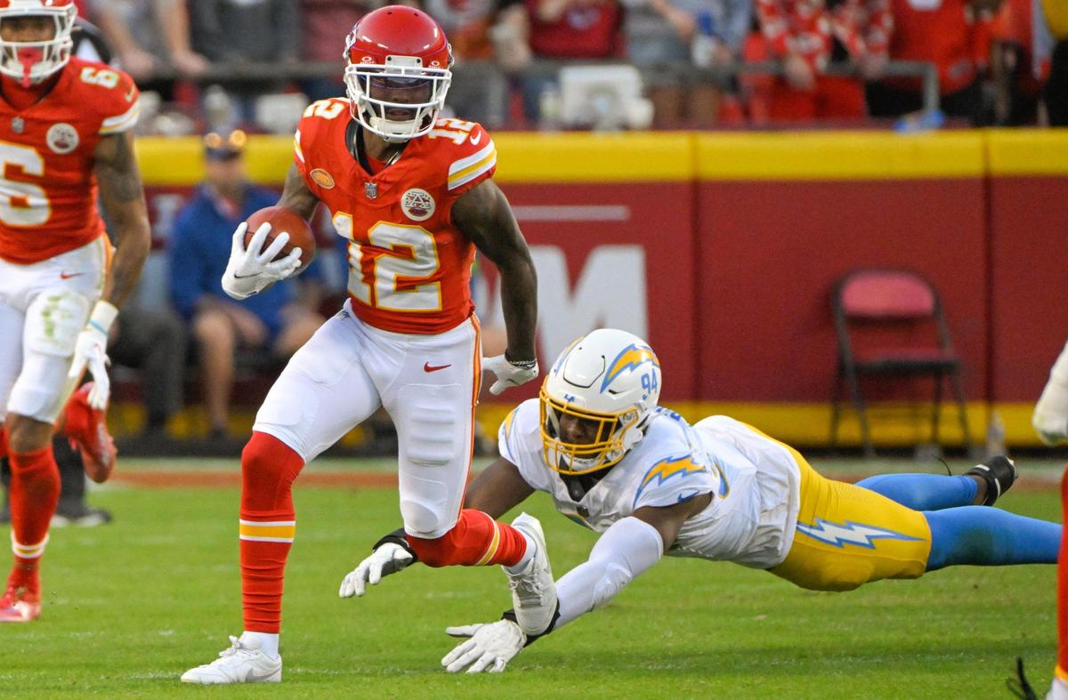 Kansas City Chiefs wide receiver Mecole Hardman Jr. (12) returns a punt as Los Angeles Chargers linebacker Chris Rumph II (94) misses a tackle during an NFL football game at GEHA Field at Arrowhead Stadium on Monday, Oct. 23, 2023, in Kansas City.