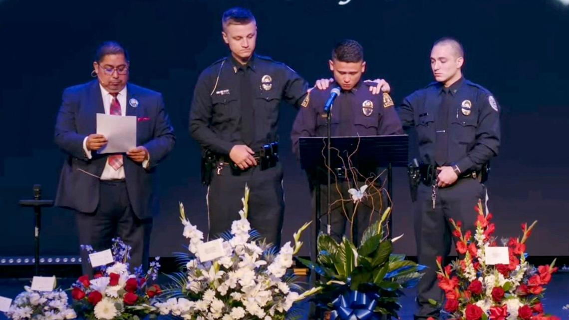Independence police officer Nicolas Pablo, at podium, is supported by fellow police officers while he shares his memories of North Kansas City police officer Daniel Vasquez during Vasquez’s funeral ceremony on July 27, 2022, at Vineyard Church in Kansas City. 