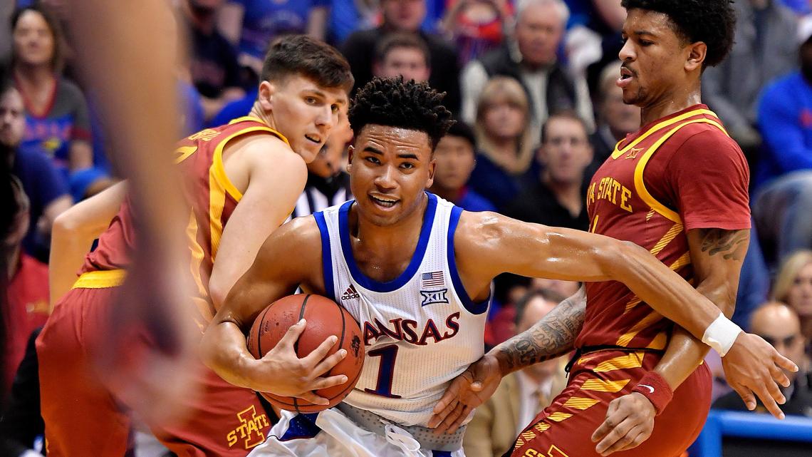 KU’s Devon Dotson blasted through a double team by ISU’s Caleb Grill, left, and Prentiss Nixon on his way to the basket during the first half of Monday night’s Big 12 Conference game at Allen Fieldhouse.