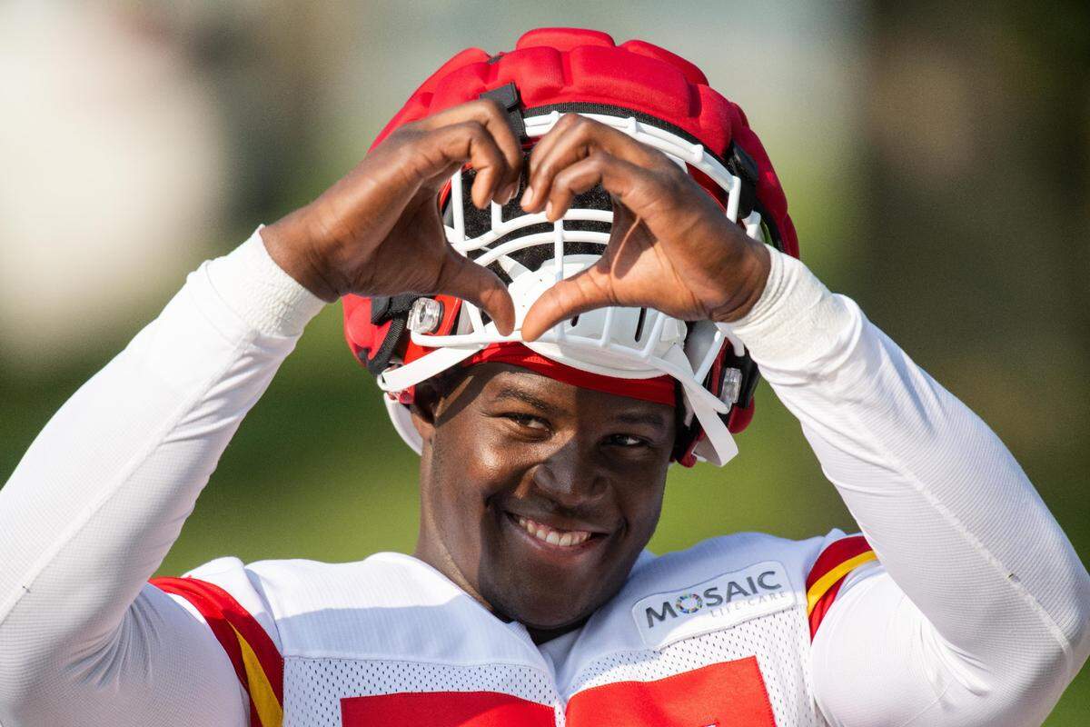 Kansas City Chiefs defensive end Truman Jones flashes a heart symbol to fans at training camp in St. Joseph.