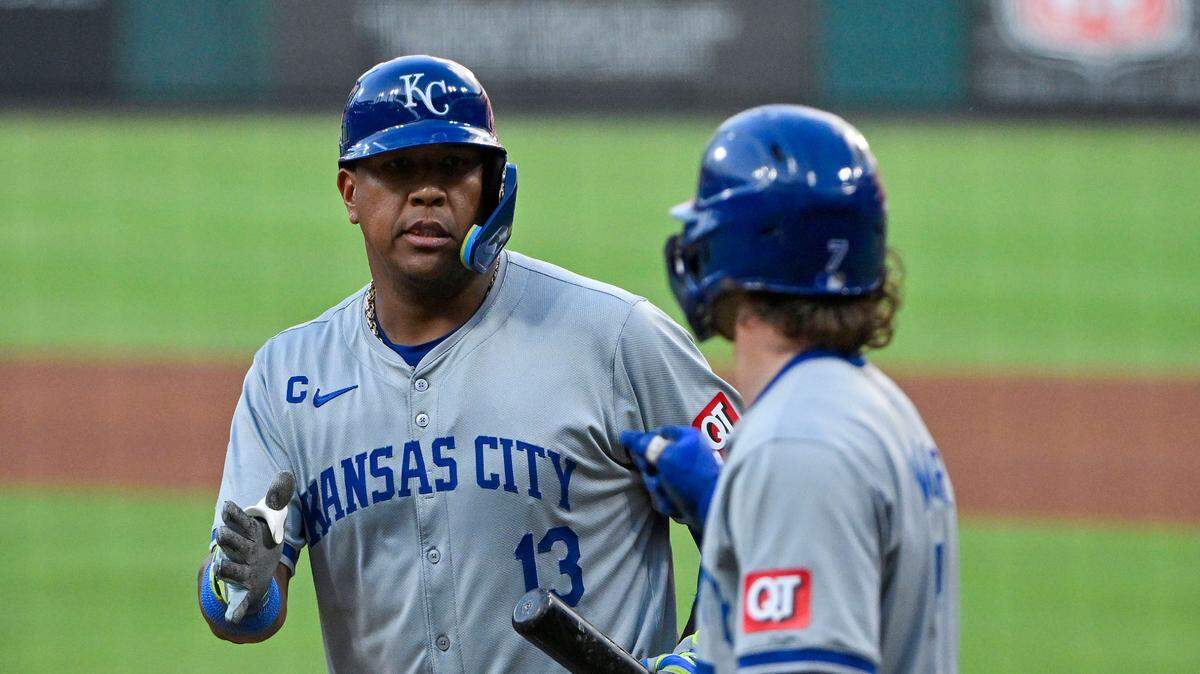 Kansas City Royals designated hitter Salvador Perez (13) is congratulated by shortstop Bobby Witt Jr. (7) after hitting a one run sacrifice fly against the St. Louis Cardinals during the fourth inning at Busch Stadium on Jul 10, 2024 in St. Louis, Missouri, USA.
