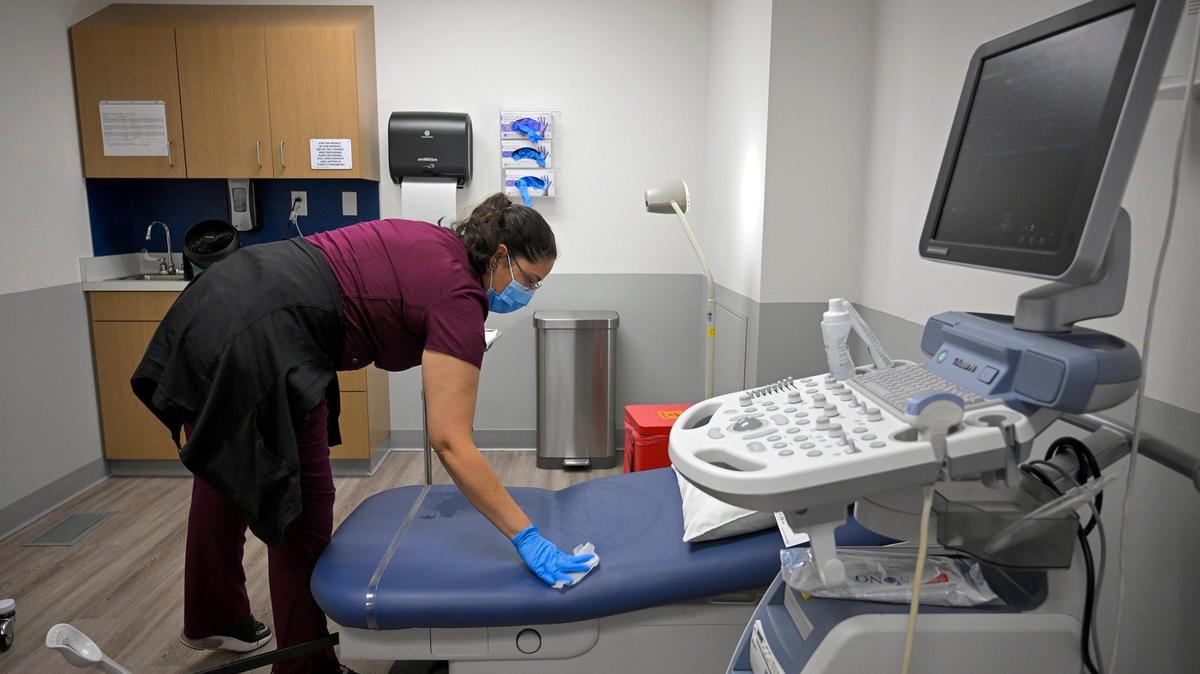 A registered nurse prepares an exam room for a patient at the Planned Parenthood health center in Kansas City, Kansas.
