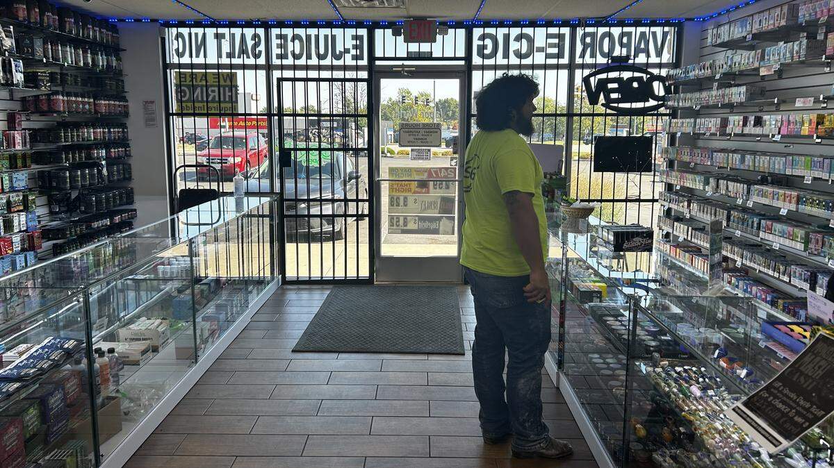 A customer making a purchase at Vapor World, a Northland smoke shop.