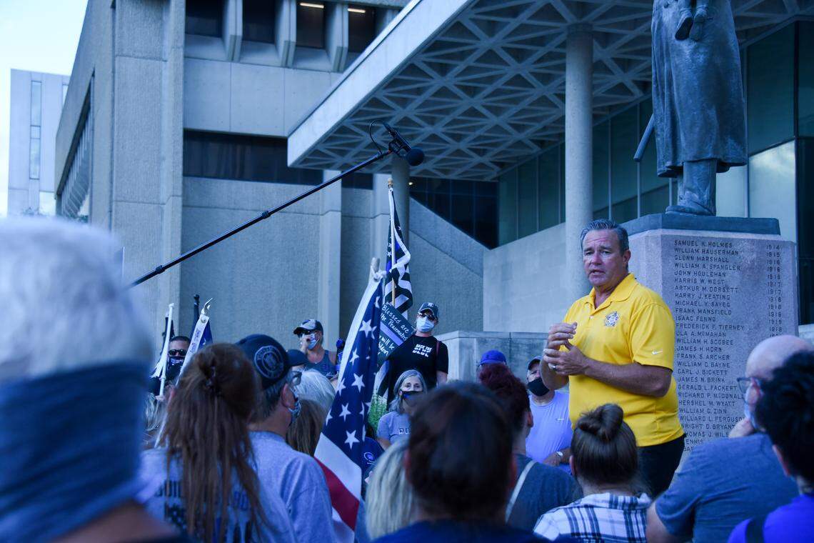 Kansas City Fraternal Order of Police President Brad Lemon, seen at right in a yellow shirt, addresses a crowd at a July 28 rally in support of police outside the downtown Kansas City Police Department headquarters.