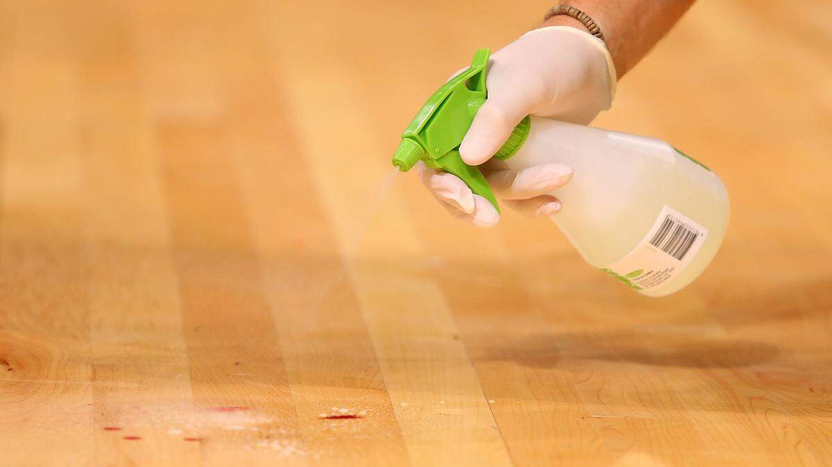 Spraying cleaner.