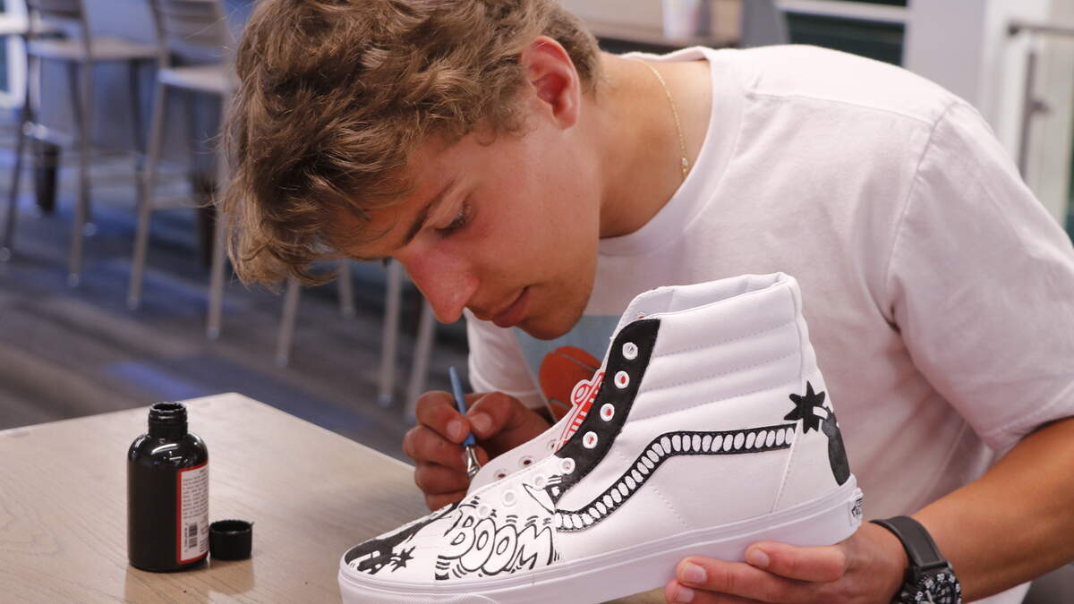 Billy Louiselle focused on the details as he painted a custom Spy vs. Spy design on a pair of shoes for rapper, Gyyps. His multi-layered creative process requires a minimum of 10 hours to design a pair of shoes.