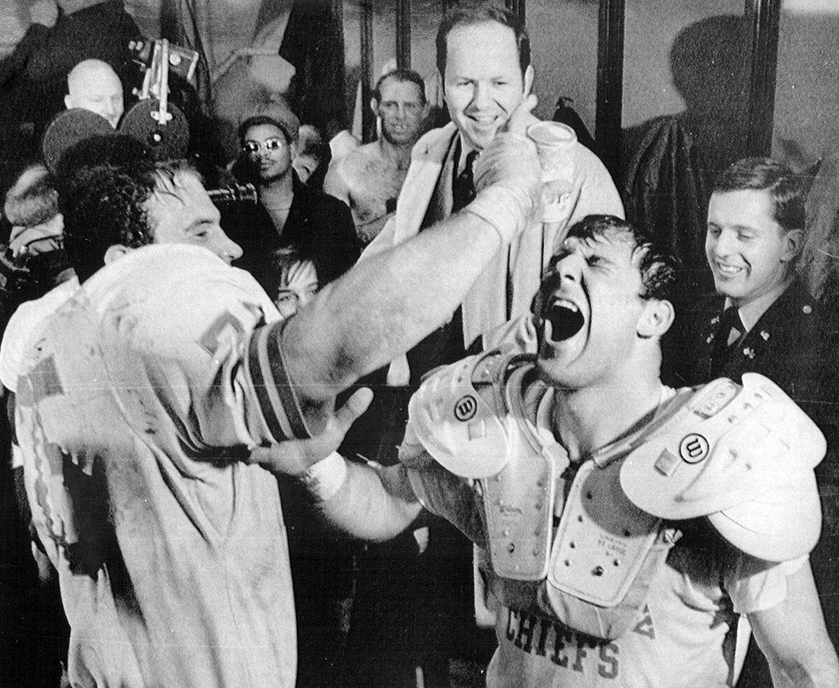 Defensive end Jerry Mays and linebacker Jim Lynch celebrate in the Kansas City Chiefs dressing room after they won the AFL title by defeating Oakland, 17-7, in 1969.