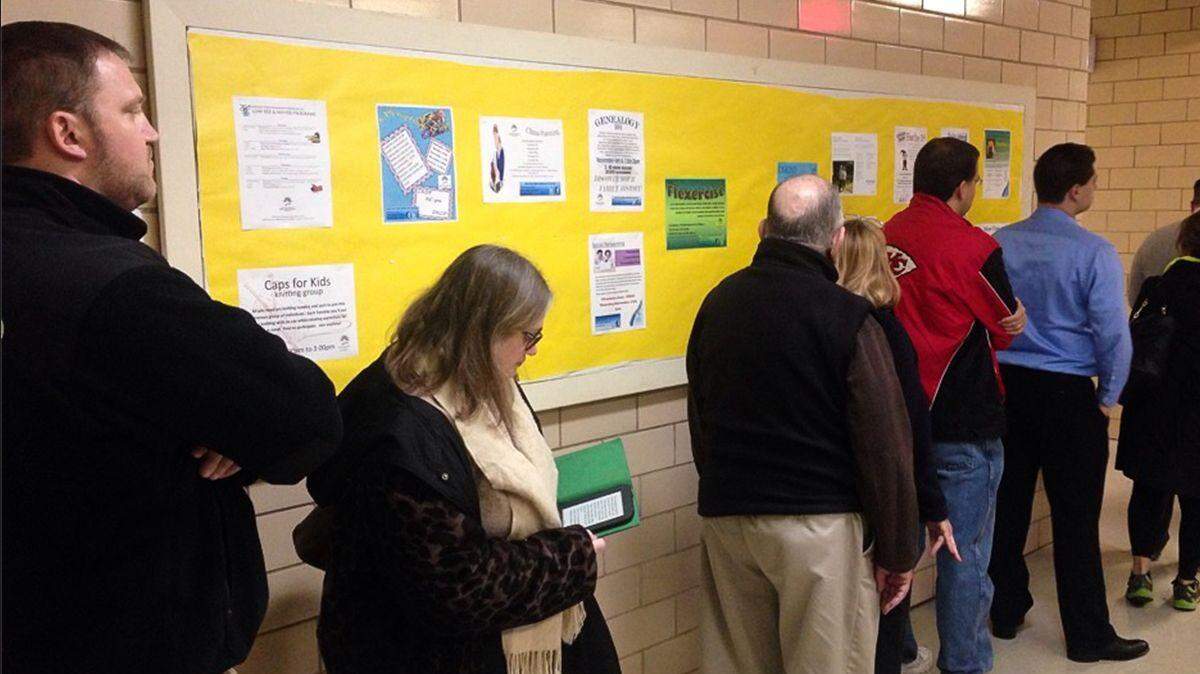 Voters wait in line to cast their ballots at the Roeland Park Community Center. The line at 8:30 am was 35 people long.