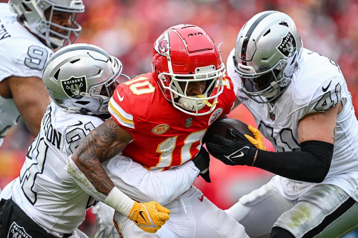 Kansas City Chiefs running back Isiah Pacheco (10) is taken down by Las Vegas Raiders cornerback Amik Robertson (21) and linebacker Robert Spillane (41) in the first quarter Monday, Dec. 25, 2023, at GEHA Field at Arrowhead Stadium.