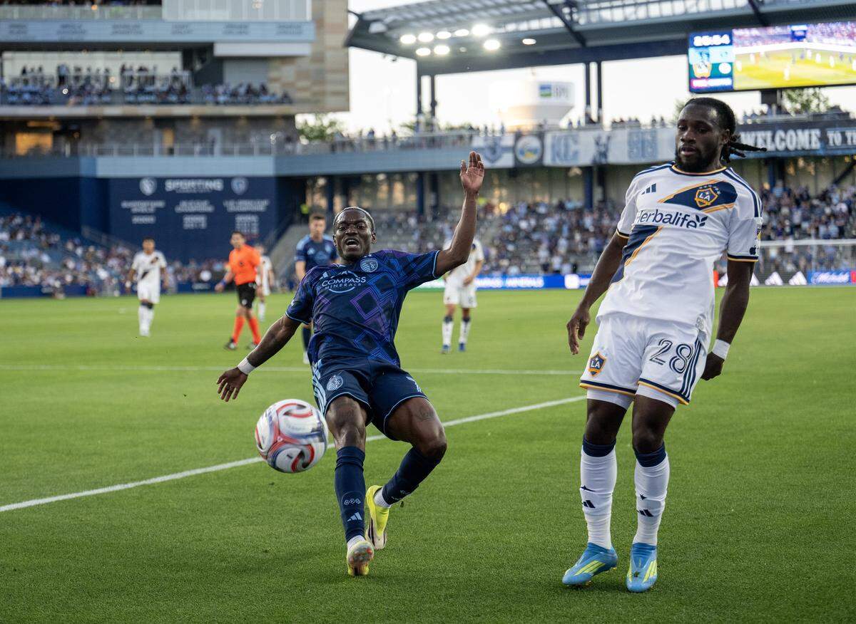 Sporting Kansas City forward Capita Capemba (7) kicks the ball as LA Galaxy forward Joseph Paintsil (28) closes in during the first half at Sporting Park on Wednesday, May 13, 2026, 2026, in Kansas City, Kansas,