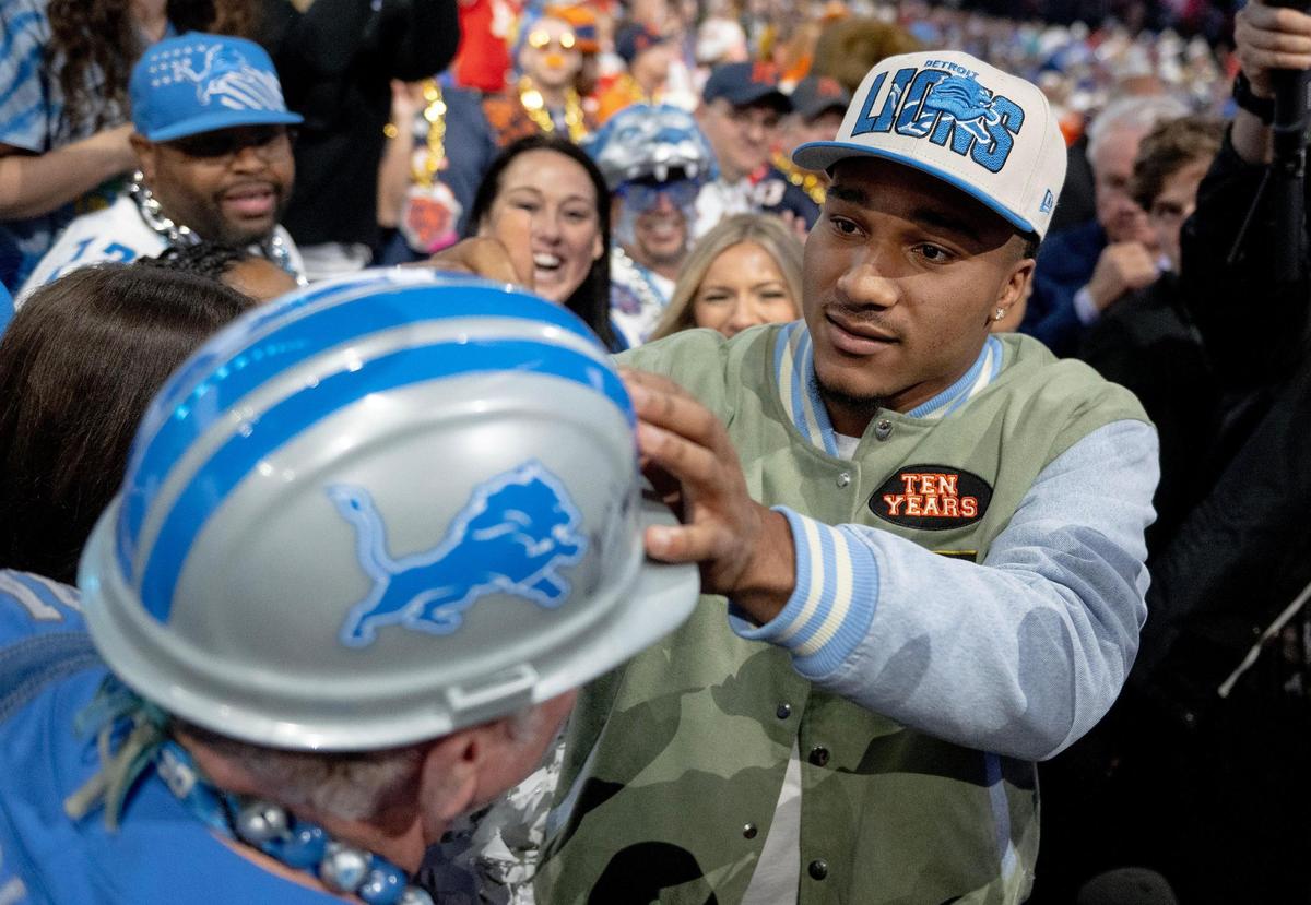 Alabama defensive back Brian Branch autographs a Detroit Lions fan’s hard hat after being picked 45th overall by Detroit during the second round of the NFL Draft outside of Union Station on Friday, April 28, 2023, in Kansas City.