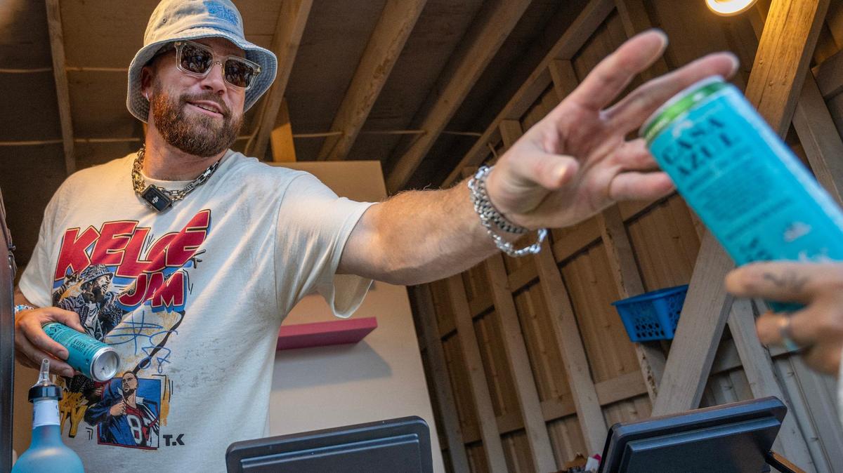 Kansas City Chiefs tight end Travis Kelce hands out Caza Azul Spirits to fans during Kelce Jam at the Azura Amphitheater on Saturday, May 18, 2024, in Bonner Springs, Kansas.