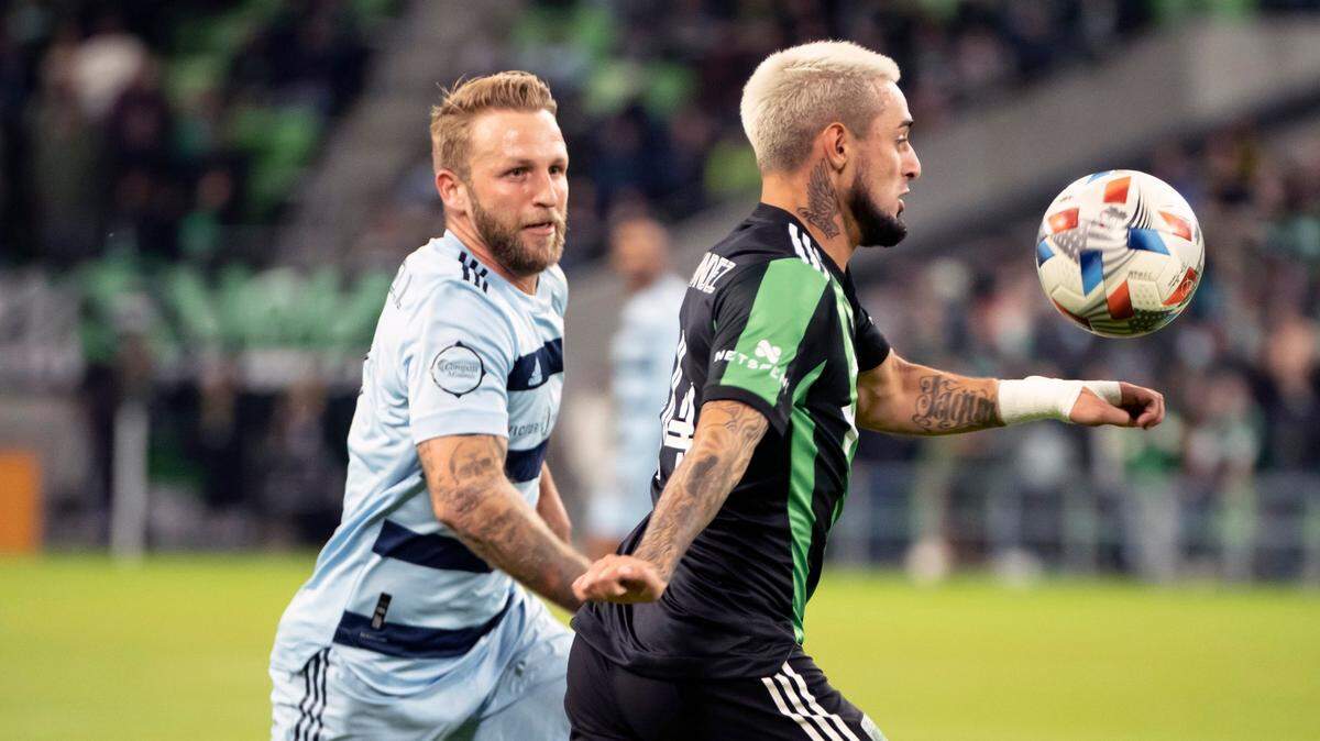 Austin FC midfielder Diego Fagundez, right, chases down the ball in front of Sporting Kansas City forward Johnny Russell Wednesday night in Austin.