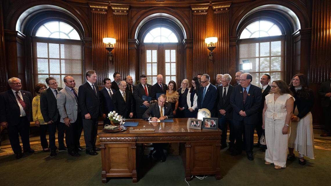 Missouri Gov. Mike Kehoe signs House Bill 2061 in the Governor’s Office on Thursday. The bill is aimed at curbing antisemitic incidents in schools.