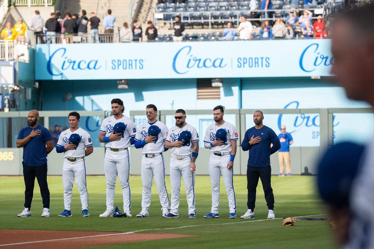 Kansas City Royals players stand during the national anthem before a game against the Boston Red Sox on Wednesday, May 20, 2026, at Kauffman Stadium.