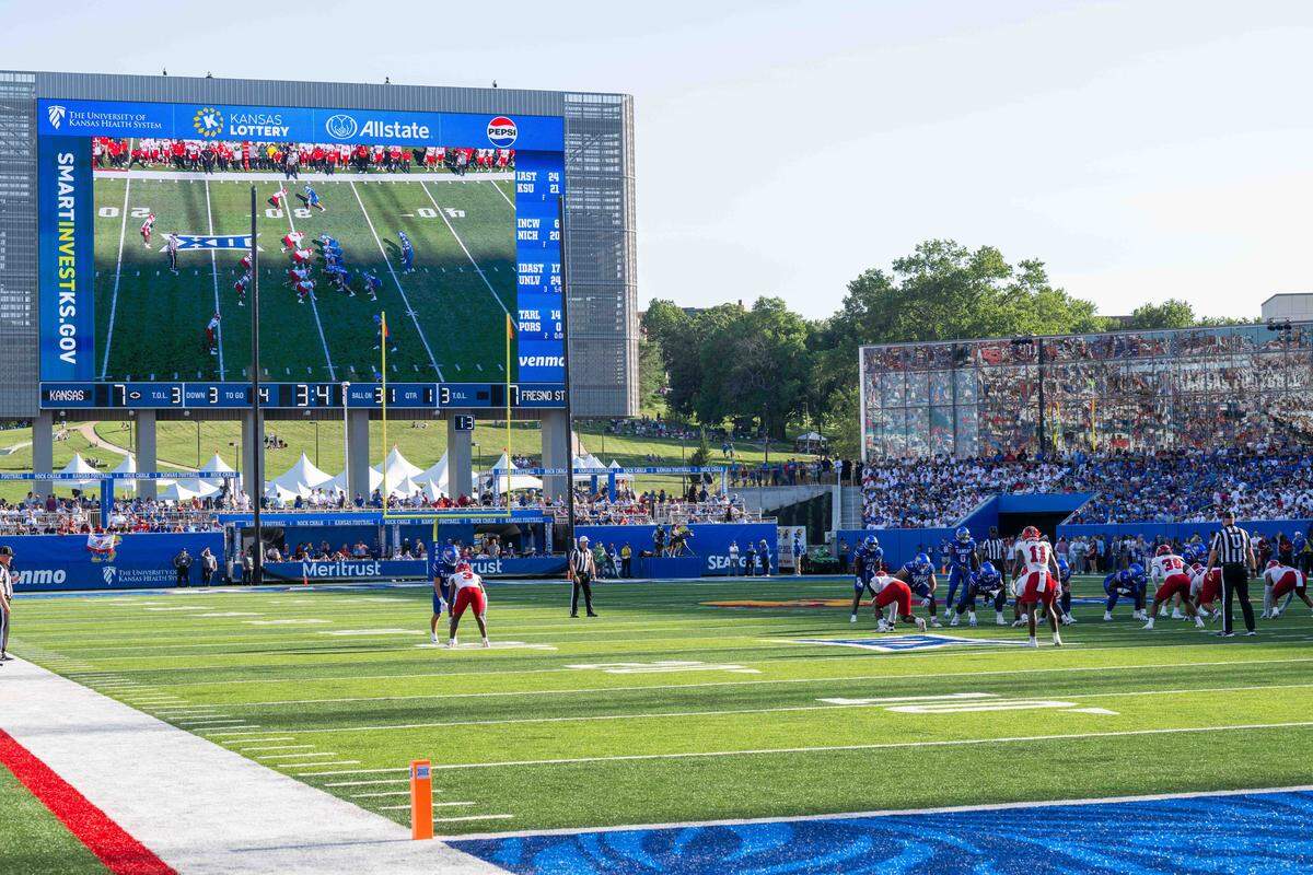 The Kansas Jayhawks offense lines up for a play in front of a newly designed players area and the massive scoreboard inside David Booth Kansas Memorial Stadium prior to the Jayhawks game vs. the Fresno State Bulldogs on Saturday, Aug. 23, 2025, in Kansas City.