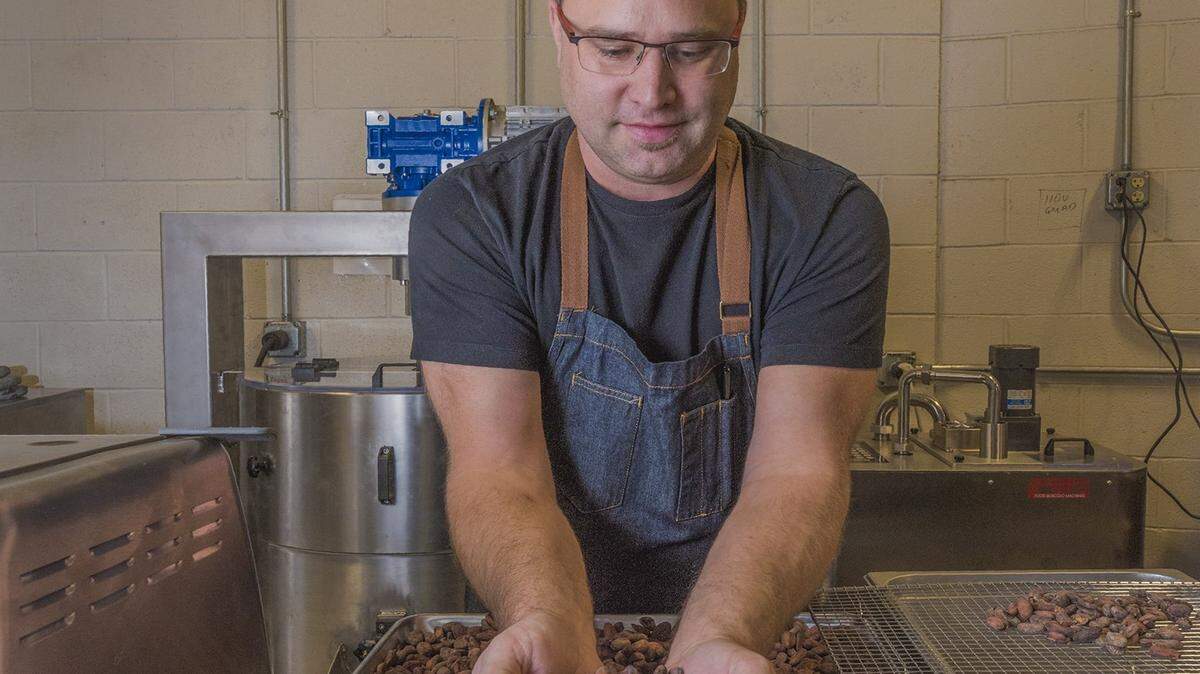 Christopher Elbow sorts chocolate beans in 2019 as the first step in creating a new line of chocolates.