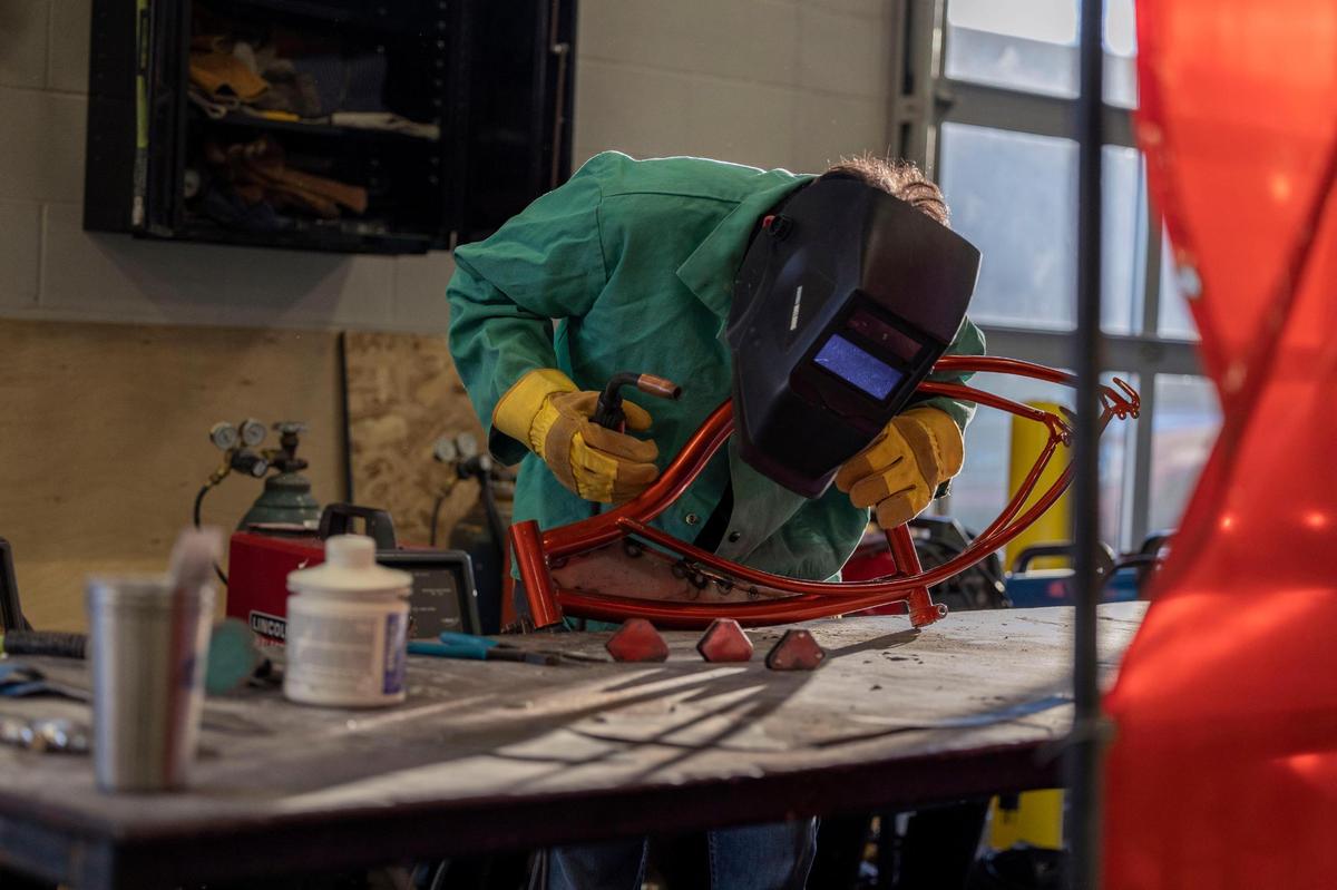 Oswaldo “Ozzy” Polanco rebuilds the frame of his 1970s-style lowrider bike. He has learned how to customize his ride through the district’s bike club, where he has met mentors who have encouraged him to graduate and go on to college.