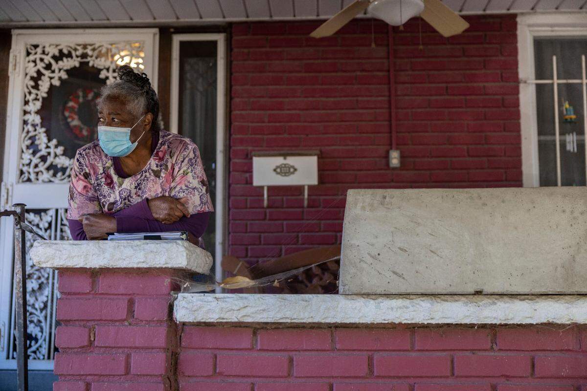 Barbara Johnson looks out on the homes from her front porch along Chestnut Avenue in her East Side neighborhood. Johnson thinks people should have been given the chance to rehab derelict homes rather than have the city come through and tear them down.