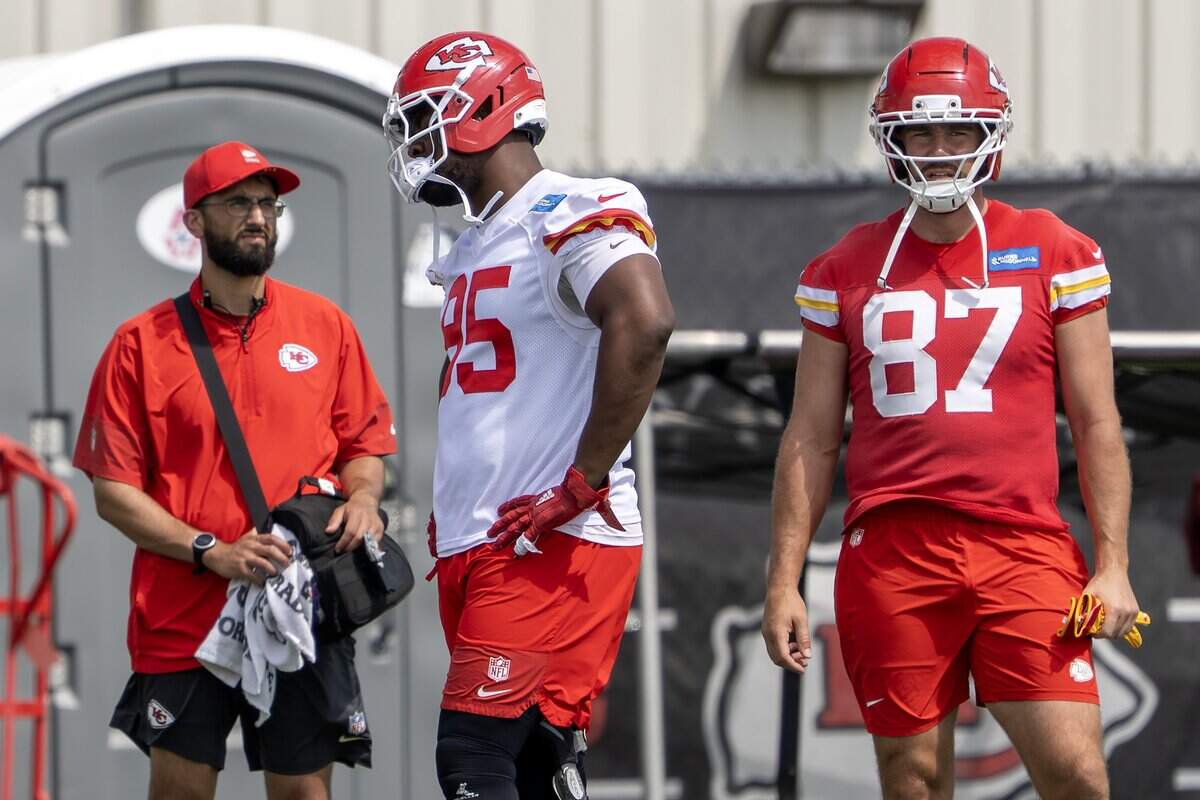 Kansas City Chiefs defensive tackle Chris Jones (95), left, and tight end Travis Kelce (87) warm up during minicamp practice at the Chiefs' practice facility on Wednesday, June 10, 2026, in Kansas City.