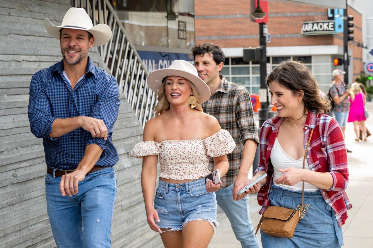 Fans walk along 13th Street to the Dierks Bentley concert at T-Mobile Center on Friday, Aug. 23, 2024, in Kansas City.