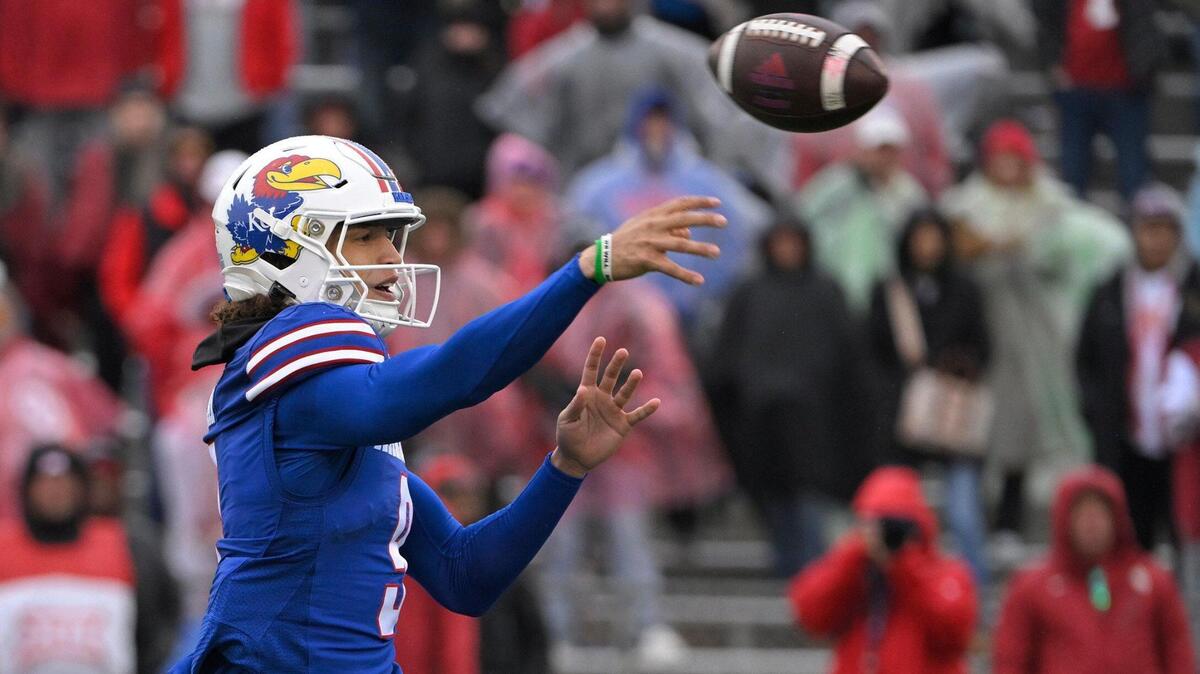 Kansas Jayhawks quarterback Jason Bean (9) looks for a receiver as he tries for a two-point conversion in the second half on Saturday, Oct. 28, 2023, at David Booth Kansas Memorial Stadium in Lawrence.