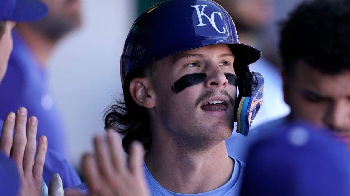 Kansas City Royals’ Bobby Witt Jr. celebrates in the dugout after scoring on a double by Vinnie Pasquantino during the third inning of a baseball game against the Seattle Mariners Sunday, Sept. 25, 2022, in Kansas City, Mo. (AP Photo/Charlie Riedel)