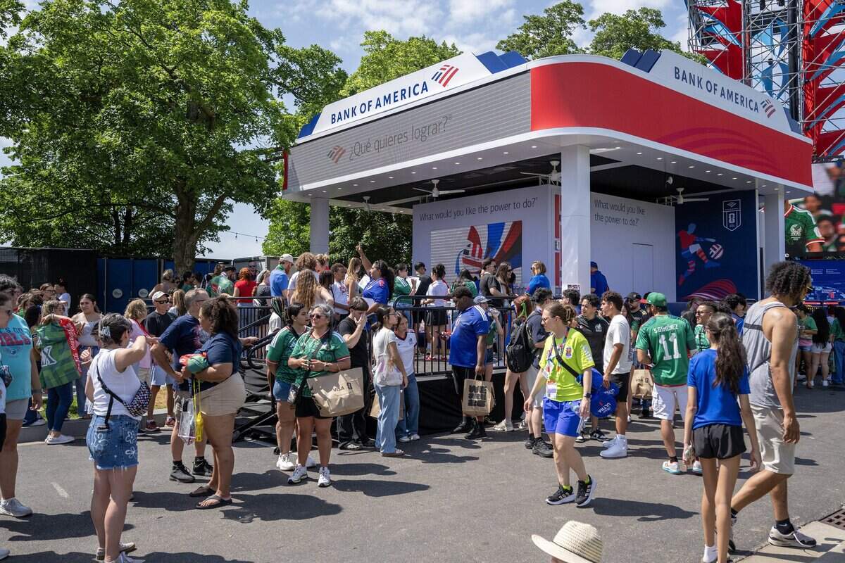 Fans stand in line to order drinks near the Bank of America booth while attending the FIFA Fan Festival on Thursday, June 11, 2026, in Kansas City.