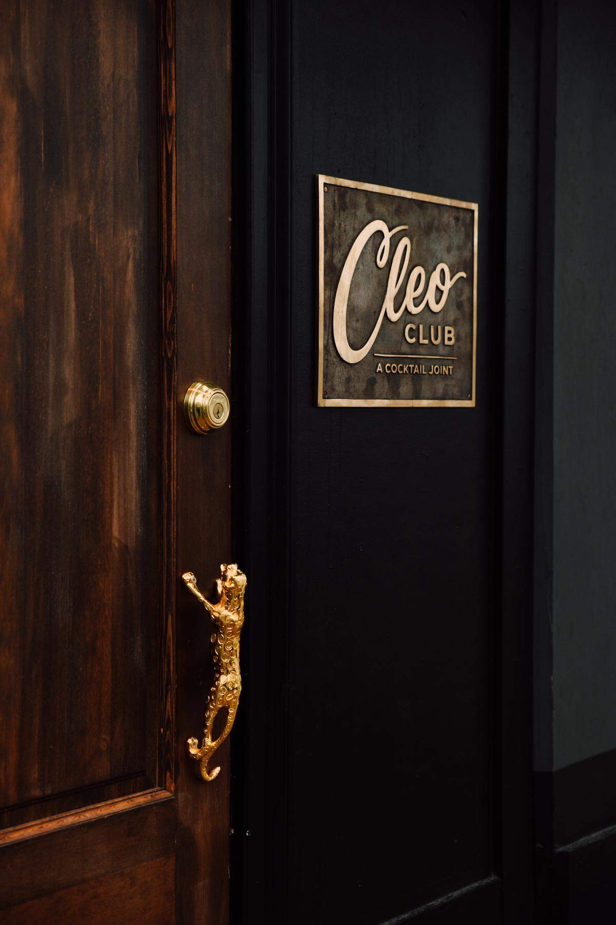 Tugging on a golden jungle cat will lead patrons inside Cleo Club, a new bar in the Crossroads.