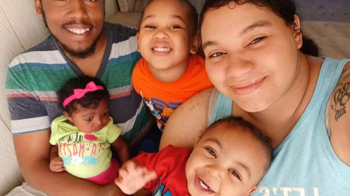 Moses Bass and Destiny Randle with their children, including son Tidus Bass, in red. Tidus Bass died after a nine-story fall from the family’s Independence Towers residence in July 2024.