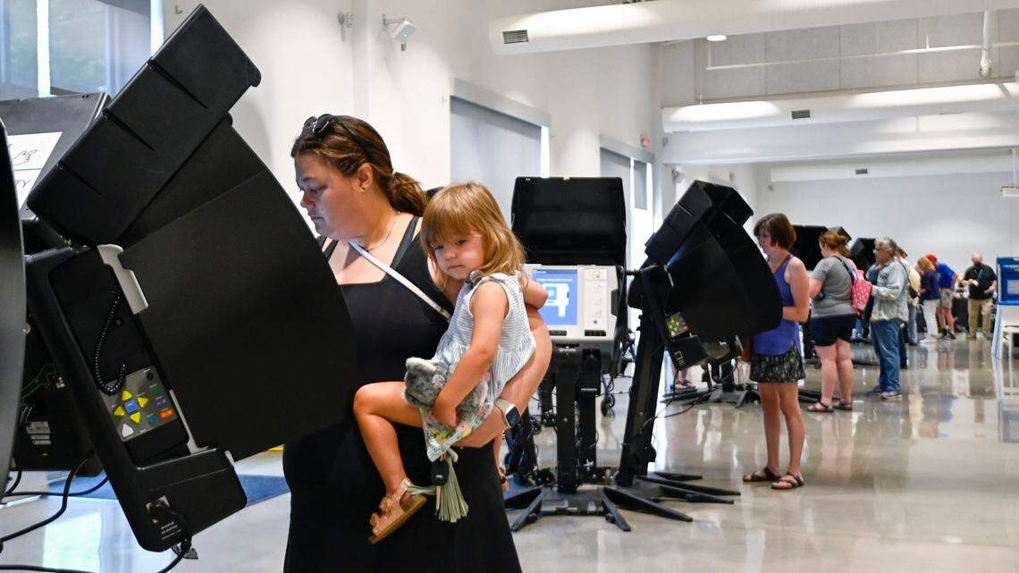 Voter Darcy Zieger of Mission held her daughter, Charlotte Zieger, 2, as she cast her ballot in the 2022 Primary Election Saturday, July 16, 2022. Data shows that recently registered voters in Johnson and Wyandotte counties are disproportionately women.