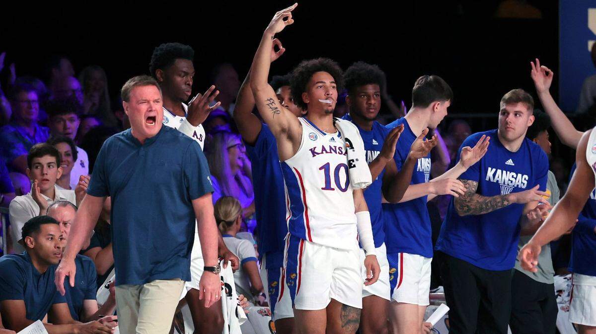 This photo provided by Bahamas Visual Services shows Kansas coach Bill Self, left, and members of his team reacting against NC State at the Battle 4 Atlantis at Paradise Island, Bahamas on Nov. 23, 2022.