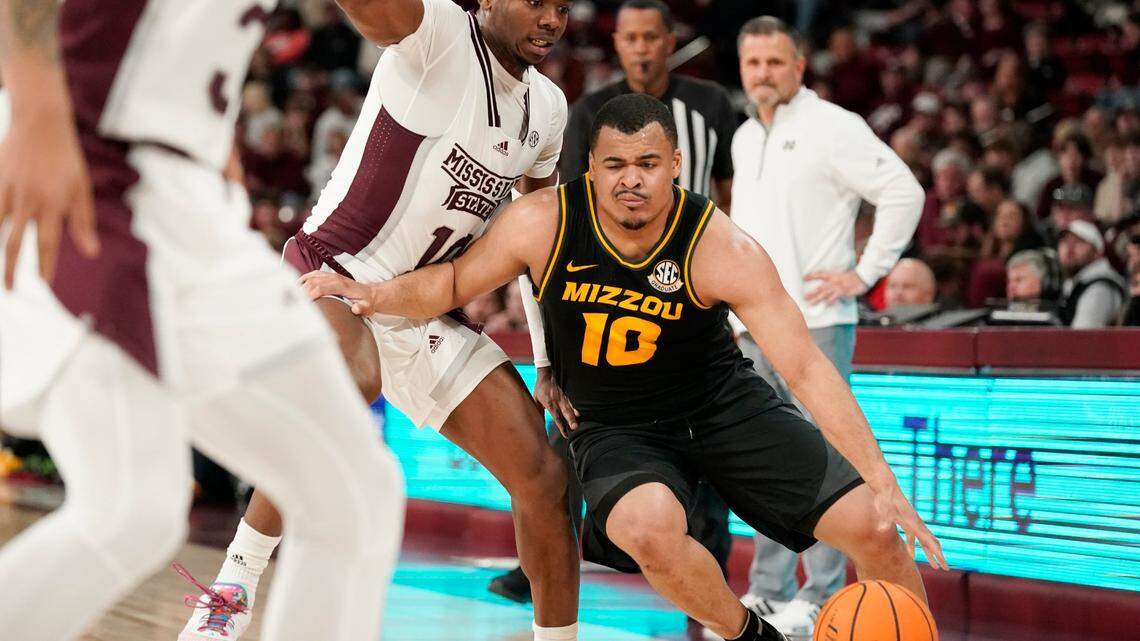 Missouri guard Nick Honor (10) tries to dribble past Mississippi State guard Dashawn Davis during the first half of a game in Starkville, Miss., Saturday, Feb. 4, 2023.