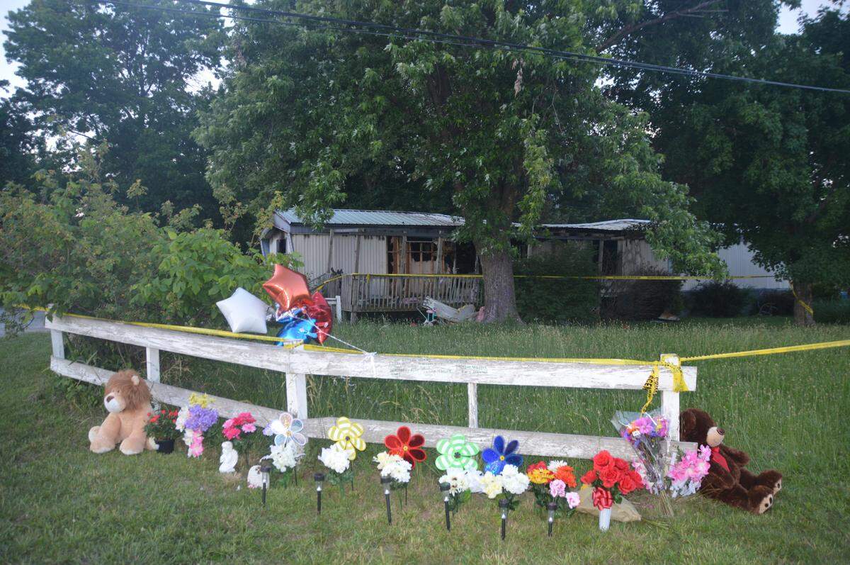 After five children were killed in a fire at a Lebanon, Mo., home, neighbors brought flowers and other items to memorialize them.
