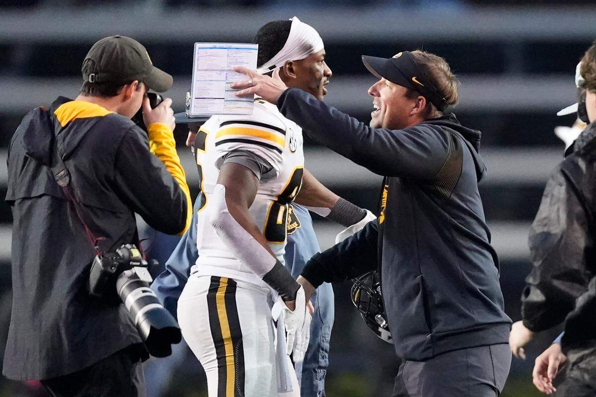 It was a happy Saturday for Missouri coach Eliah Drinkwitz, right, who celebrated with wide receiver Tauskie Dove after the Tigers beat Vanderbilt 37-28 in Nashville.