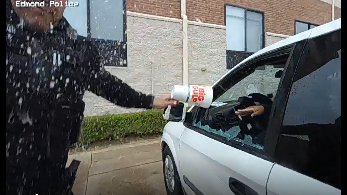 The woman throws a cup of urine into an officer’s face.