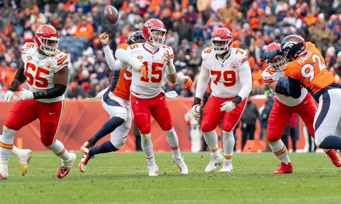 Denver Broncos linebacker Baron Browning (56) forces a fumble from Kansas City Chiefs quarterback Patrick Mahomes (15) during an NFL football game at Empower Field at Mile High on Sunday, Oct. 29, 2023, in Denver.
