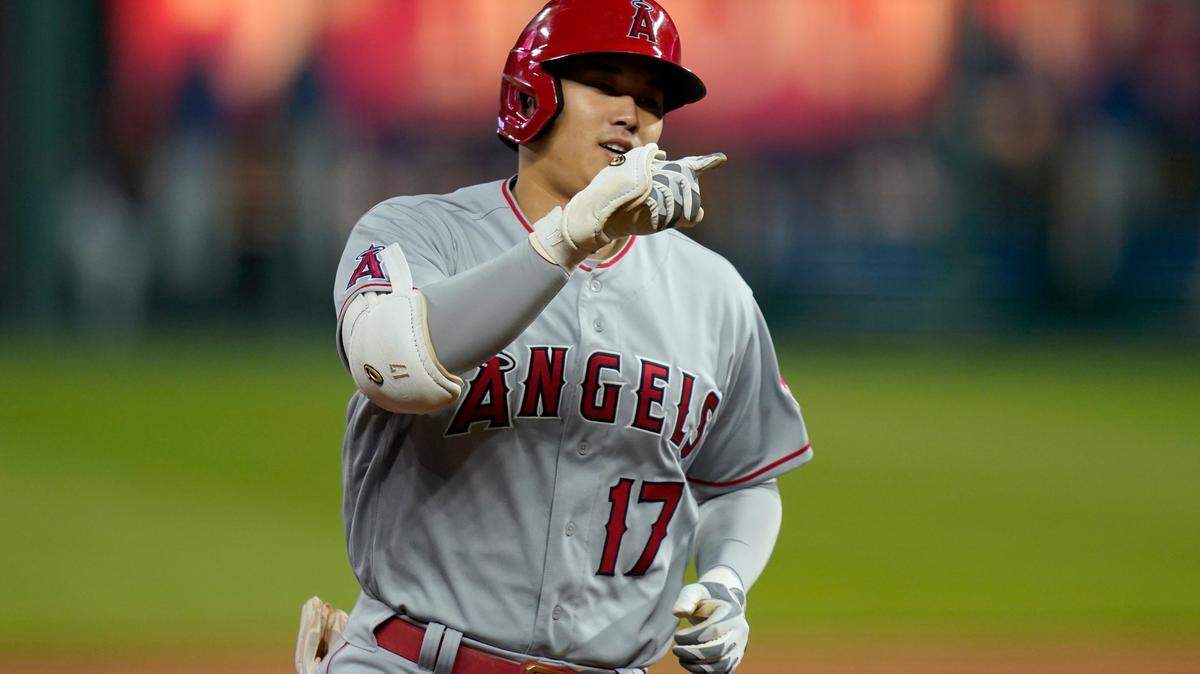 Los Angeles Angels designated hitter Shohei Ohtani gestures while rounding the bases during the fifth inning of a baseball game against the Kansas City Royals at Kauffman Stadium in Kansas City, Mo., Tuesday, April 13, 2021. Ohtani hit a solo home run on the play. (AP Photo/Orlin Wagner)