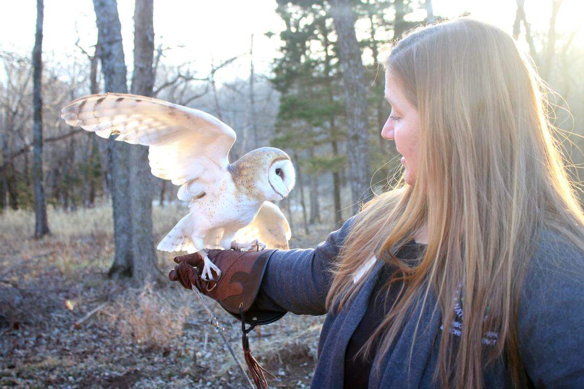 Andrea Joslin, outdoor education director at Ernie Miller Nature Center, holds a barn owl that came to the center from Junction City in 2021.