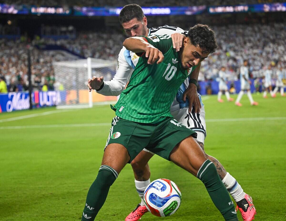 Algeria midfielder Farès Chaïbi (10) and Argentina midfielder Rodrigo de Paul (7) battle for the ball in the Argentina vs. Algeria FIFA World Cup group-stage soccer match at Kansas City (Arrowhead) Stadium in Kansas City on Tuesday, June 16, 2026.