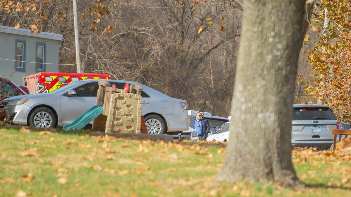 Police investigate the scene near North 55th Street and Everett Avenue, Wednesday in Kansas City, Kansas, where a man suspected of shooting a woman earlier in the day then barricaded himself in an apartment, where he’s suspected of shooting two children, killing one, before shooting himself.