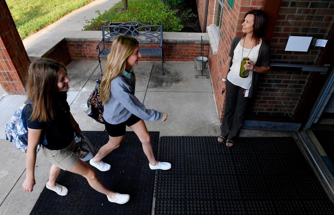 Students Abby Collins and Sadie Wilson walk into Maranatha Christian Academy in Shawnee, which has made masks optional this fall.